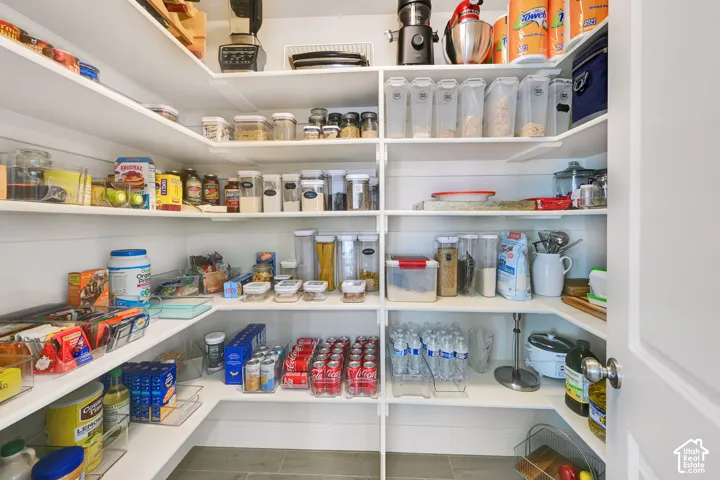 Walk-in pantry featuring extensive white shelving