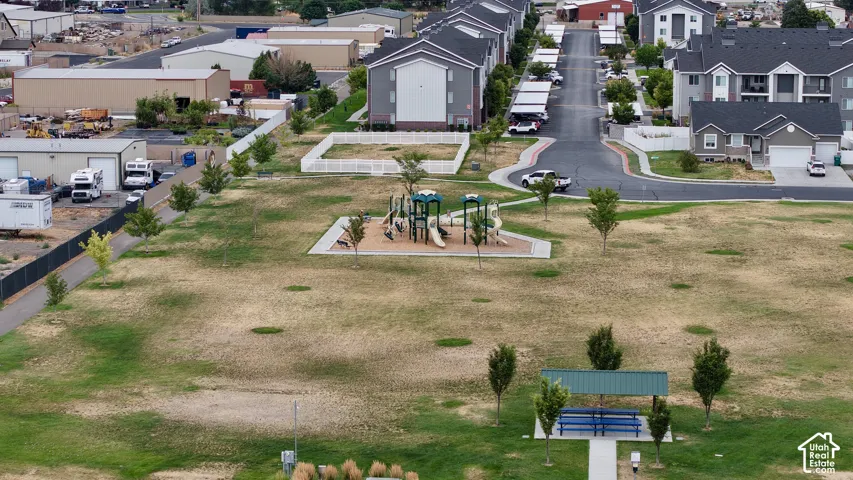 Community greenspace featuring a playground with multiple slides and a covered picnic area