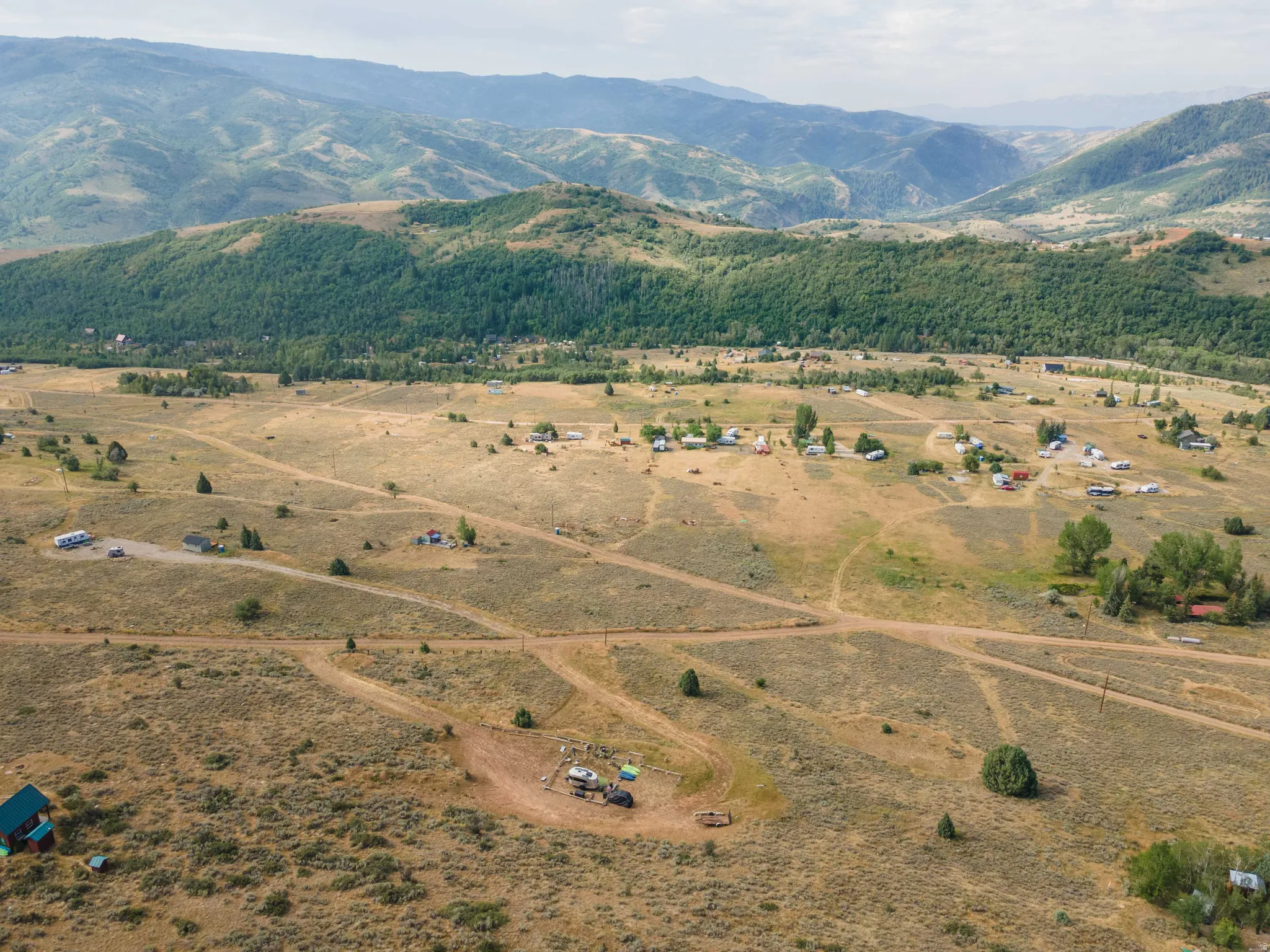 Expansive natural landscape featuring rolling hills and distant mountains