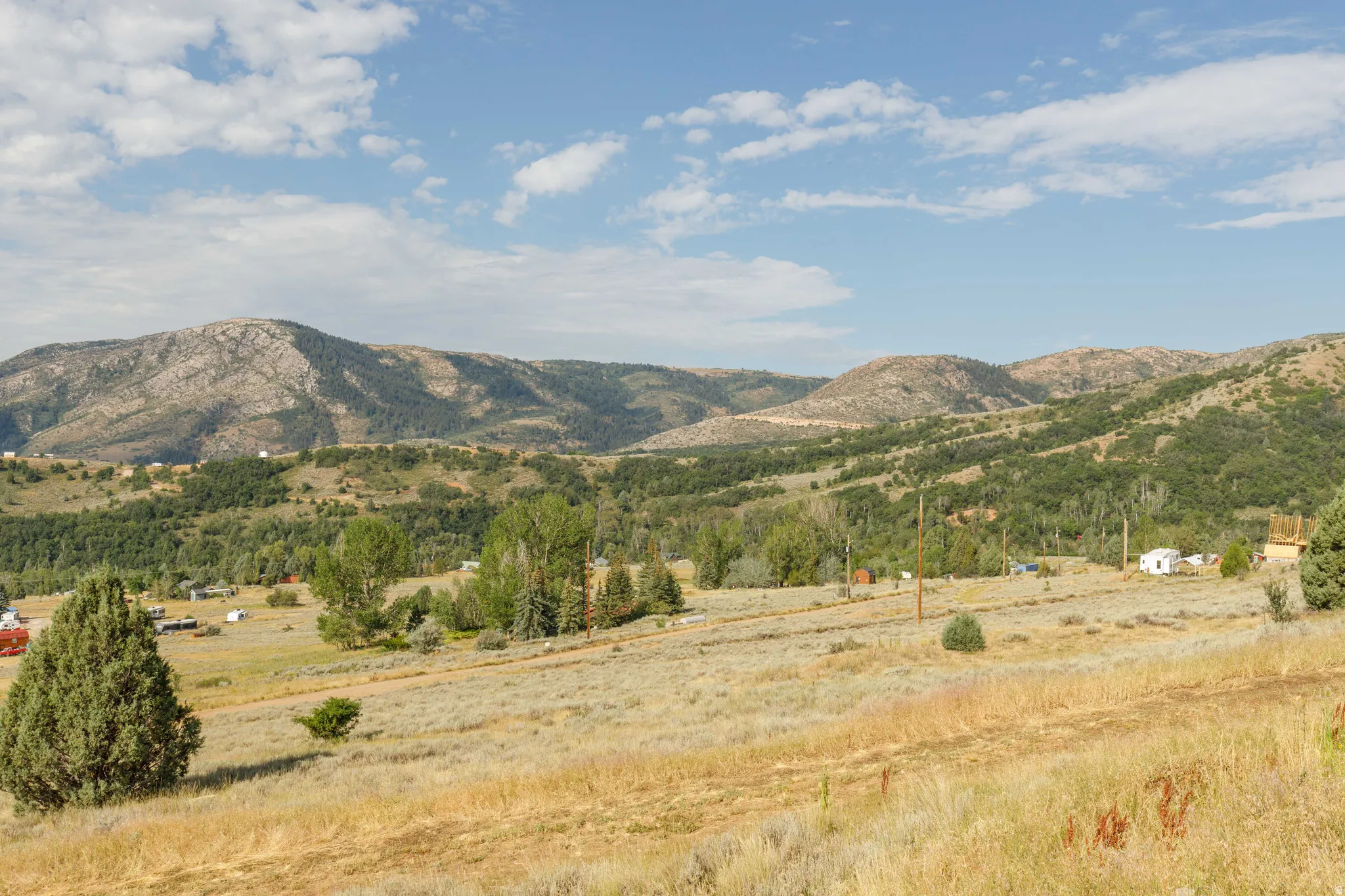 Expansive landscape featuring rolling hills and distant mountains