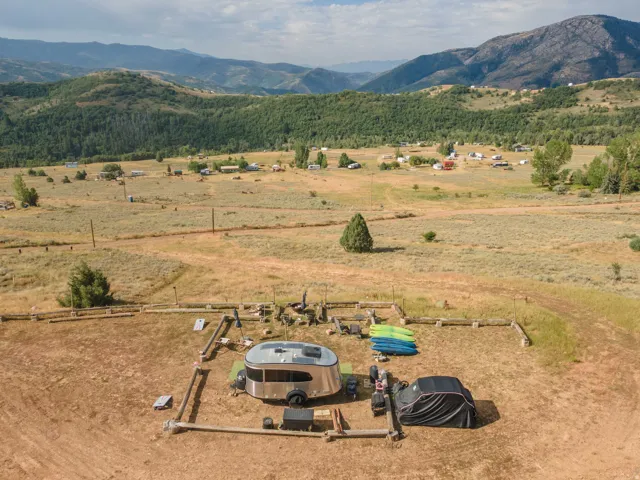 Expansive natural landscape with surrounding hills and distant structures