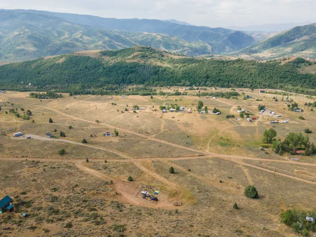 Expansive natural landscape featuring rolling hills and distant mountains
