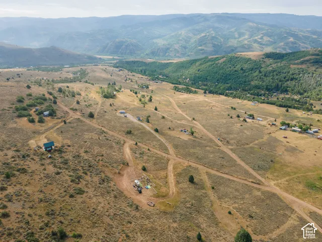 Expansive rural landscape featuring scattered residences and unpaved roads