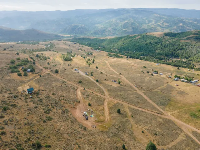 Expansive rural landscape featuring scattered residences and unpaved roads