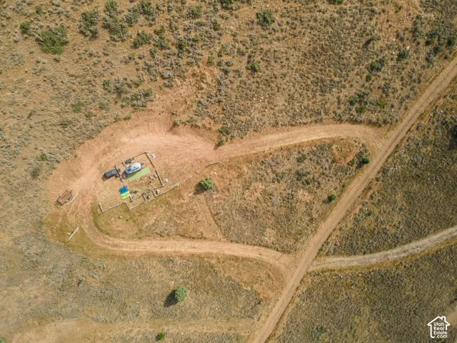 Expansive land parcel featuring natural terrain and established dirt roads