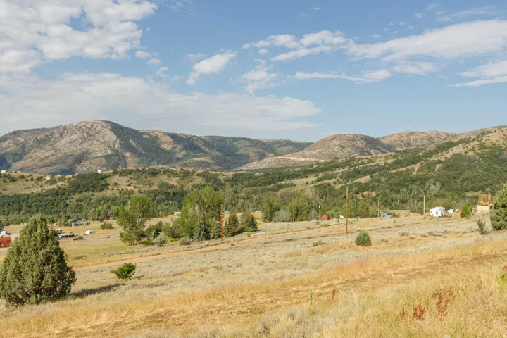 Expansive landscape featuring rolling hills and distant mountains