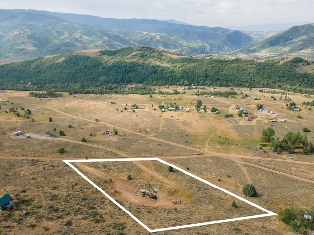 Expansive undeveloped land parcel outlined in white, featuring a natural landscape with sparse vegetation