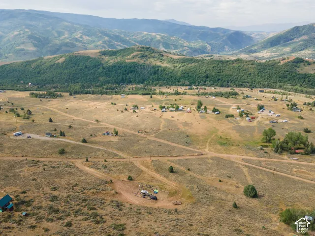 Expansive natural landscape featuring rolling hills and distant mountains