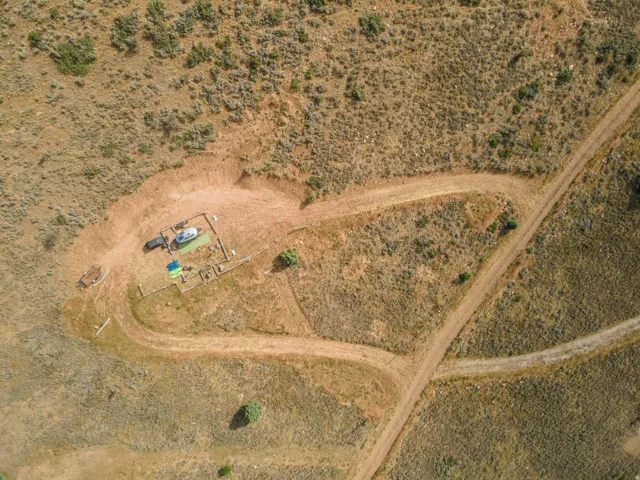 Expansive land parcel featuring natural terrain and established dirt roads