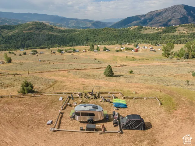 Expansive natural landscape with surrounding hills and distant structures