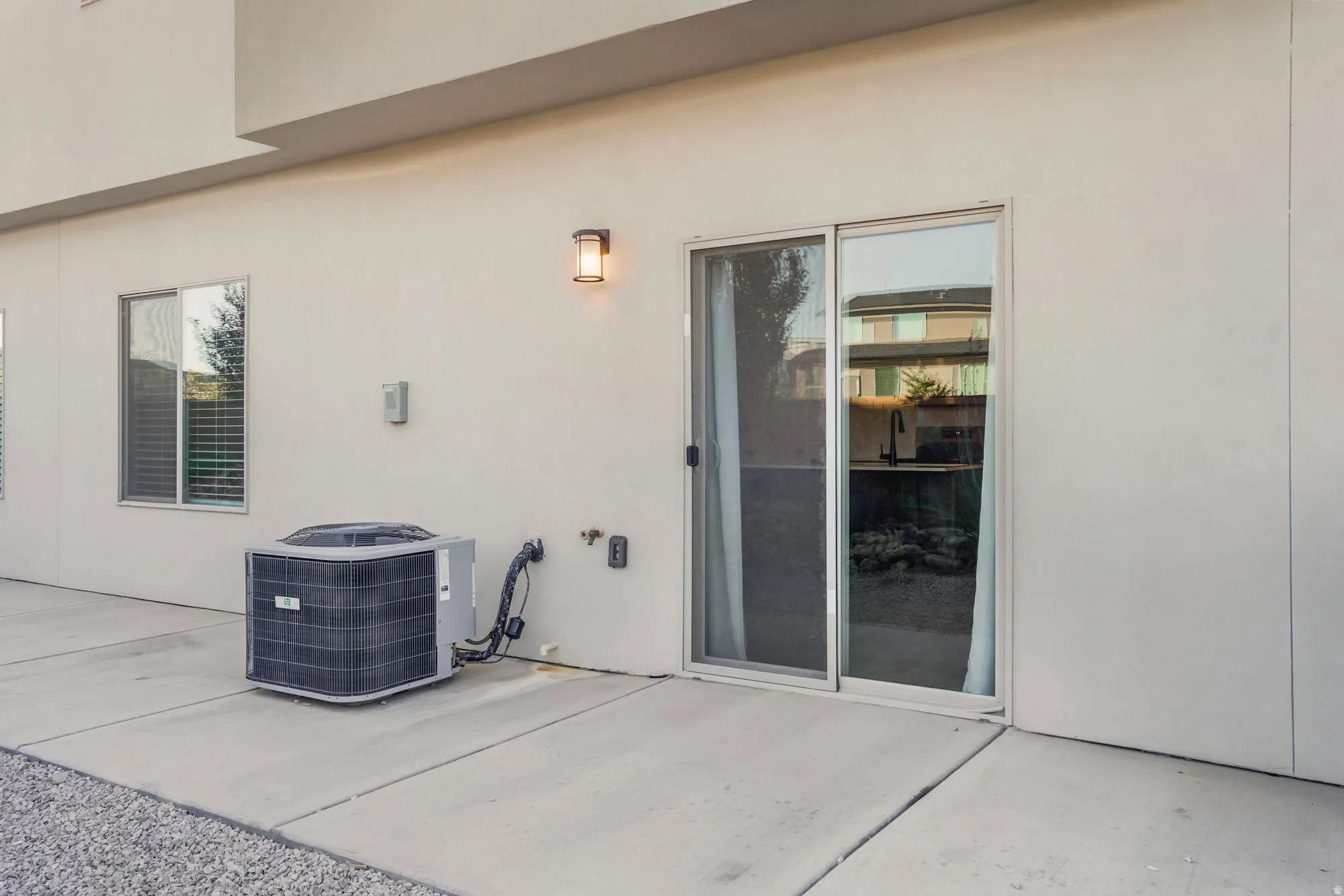 Modern patio featuring smooth concrete decking with clean sight lines to the home's glass sliding doors