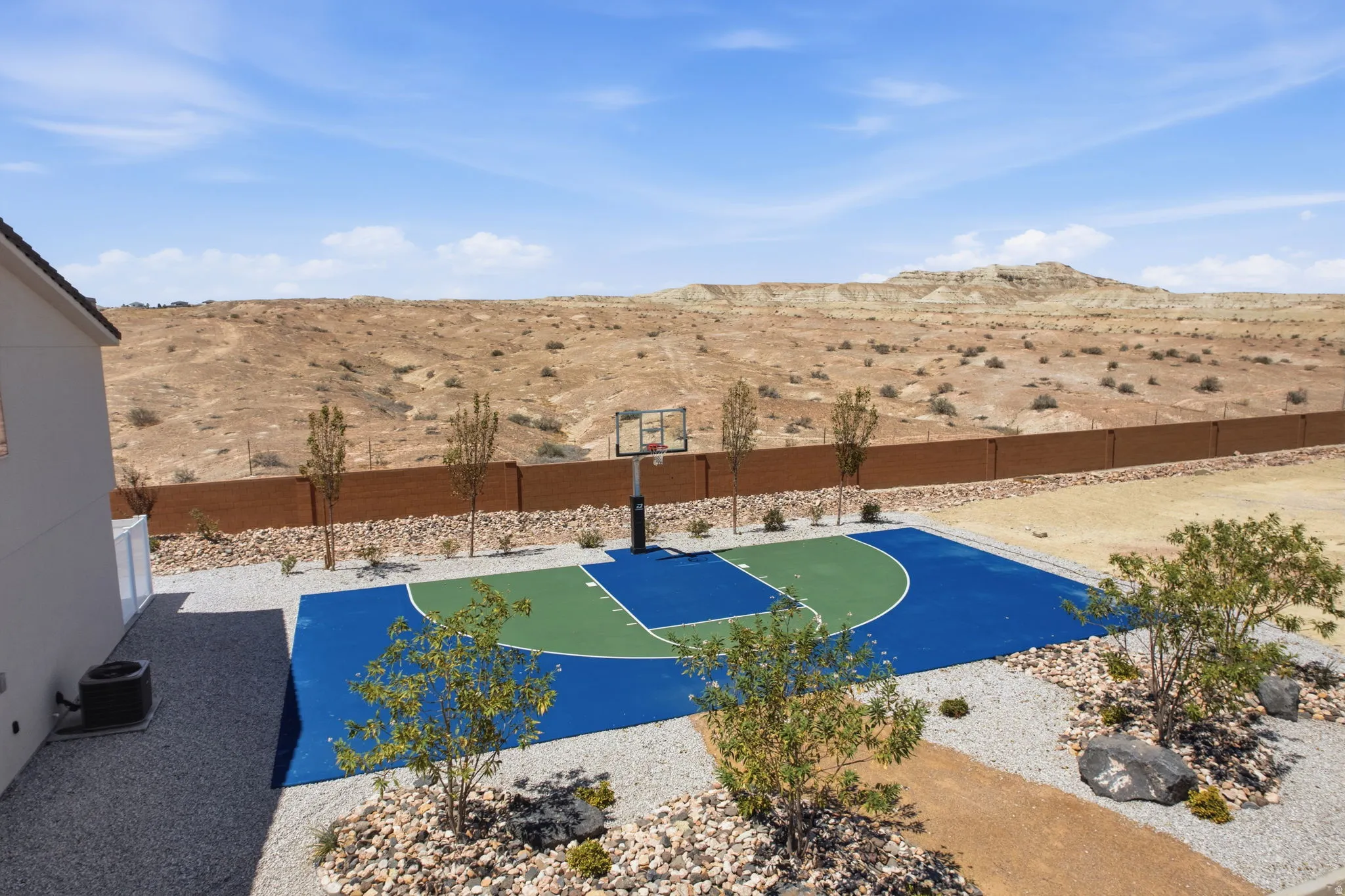 Outdoor basketball court with blue and green surfacing
