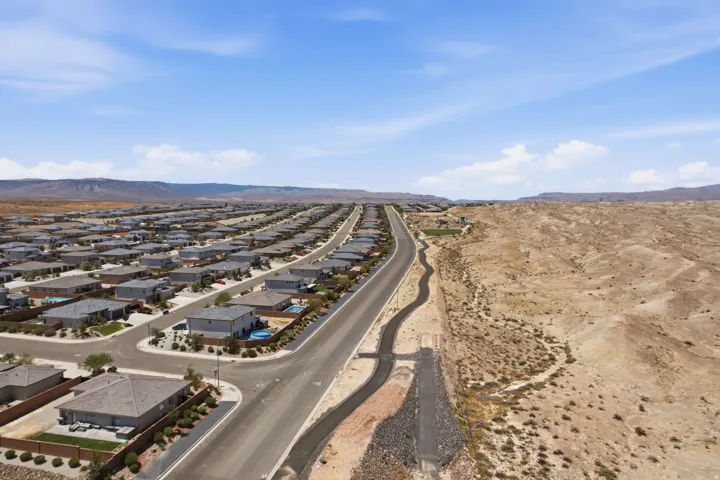 Expansive residential development with numerous single-story homes, paved streets, and desert landscaping