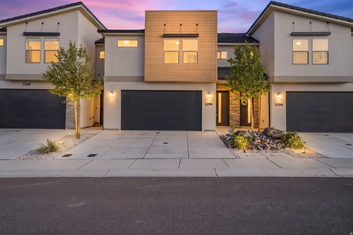 Modern townhome exterior featuring contemporary architectural design and multiple garage bays
