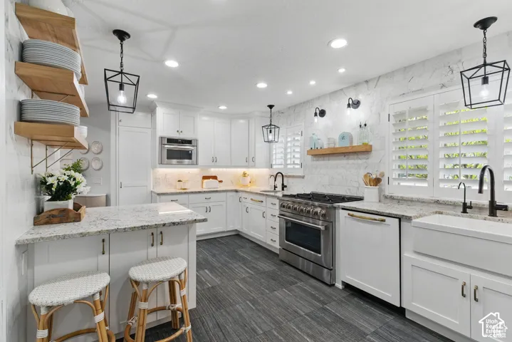 Bright kitchen featuring white cabinetry and granite countertops