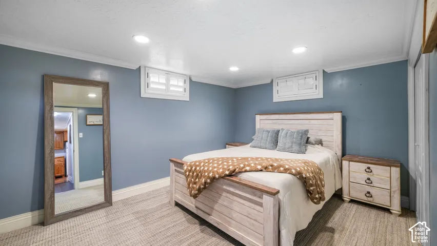 Carpeted room featuring recessed lighting and white crown molding