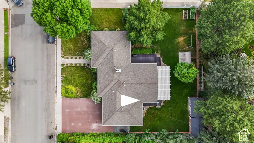 Expansive property with a gabled roofline and surrounding mature trees