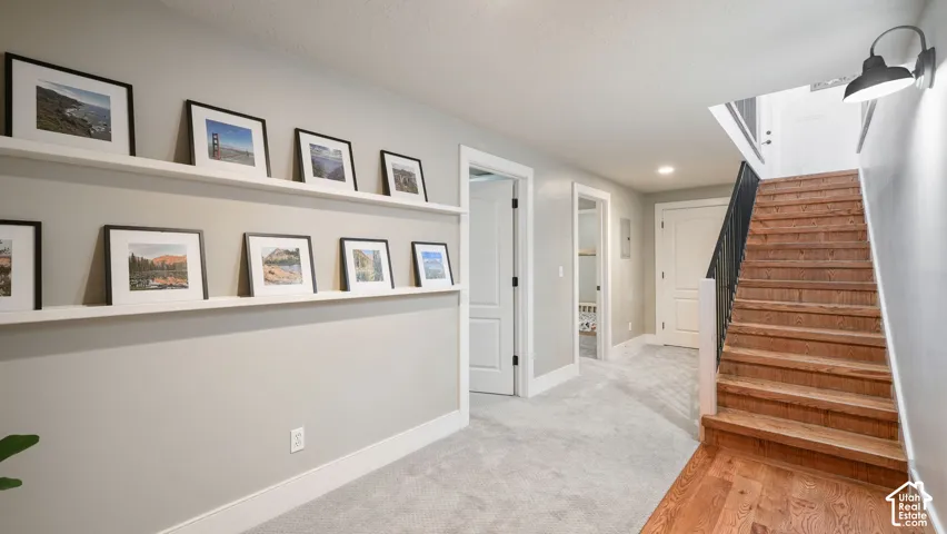 Hardwood flooring on the staircase and landing, with a contrasting black metal handrail
