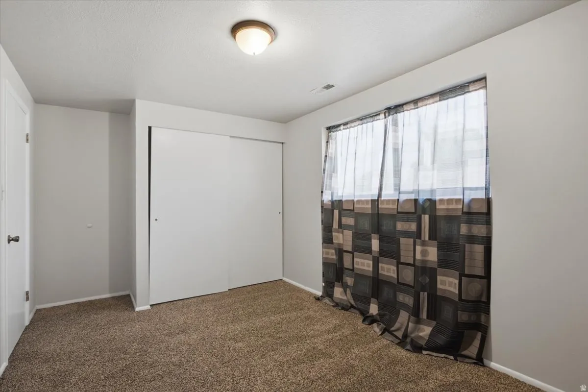 Wall-to-wall brown carpet flooring complemented by light gray painted walls