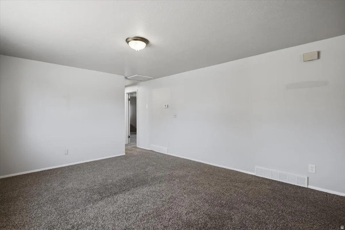 Interior room featuring neutral wall paint and plush carpeting