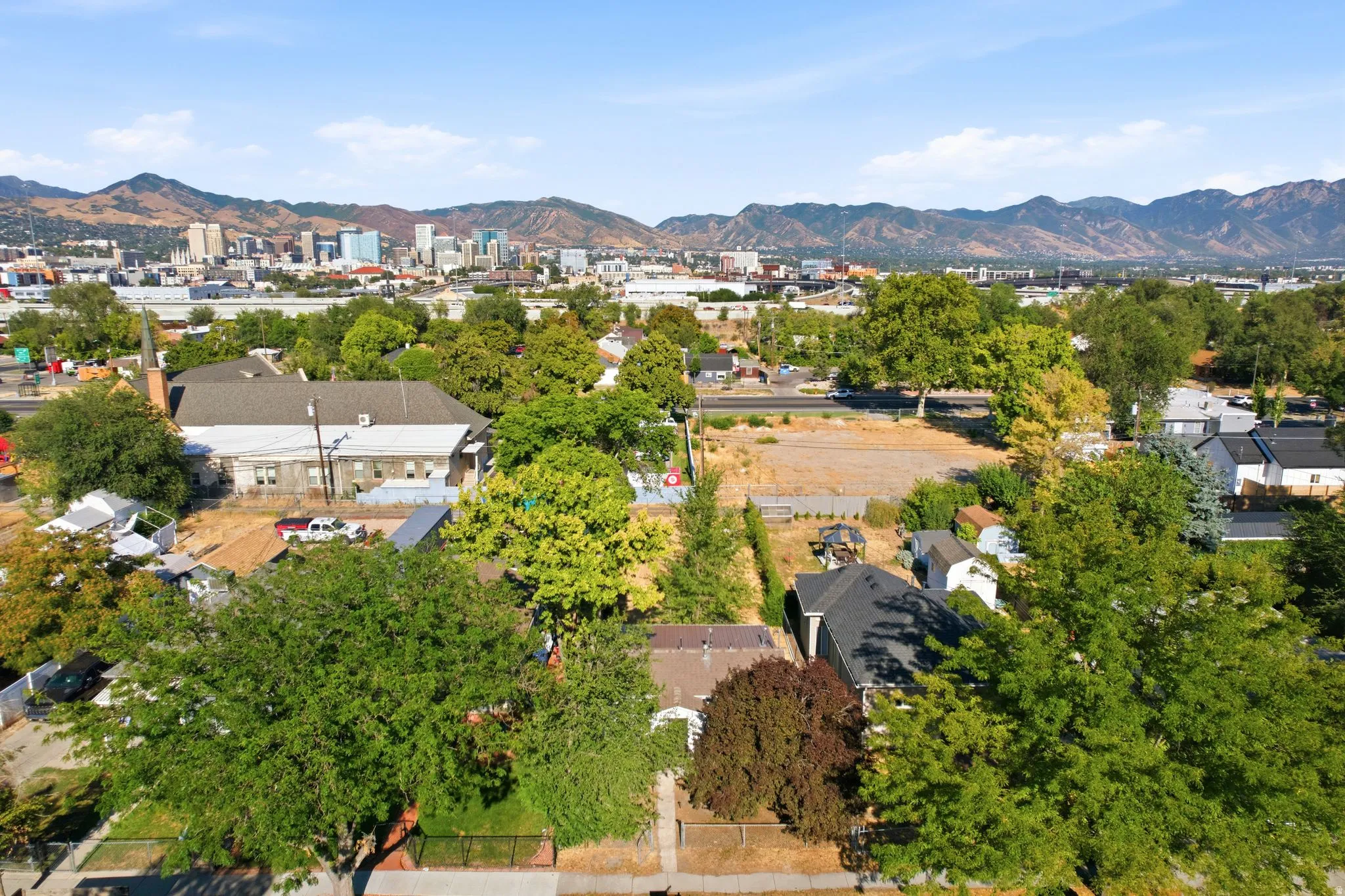 Expansive urban landscape featuring a distant cityscape and mountainous backdrop