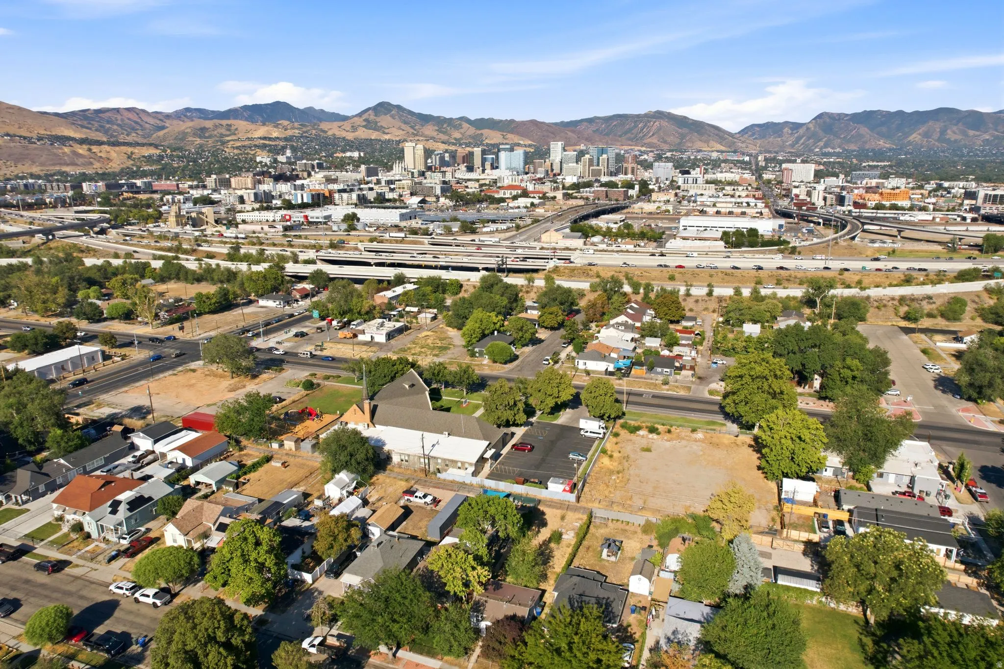 Aerial perspective showcasing a developed urban landscape with residential properties and commercial structures