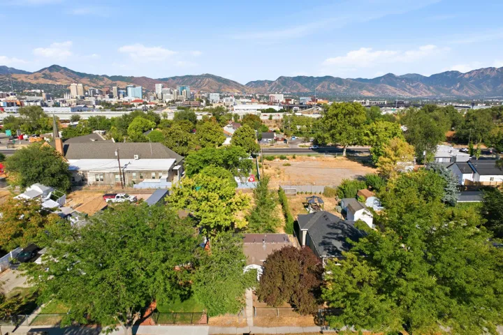 Expansive urban landscape featuring a distant cityscape and mountainous backdrop