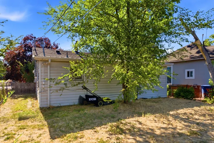 Rear exterior with horizontal siding and a dark shingle roof