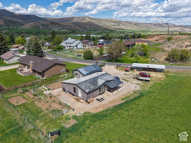 Single-story residence featuring a covered front porch and a gravel driveway