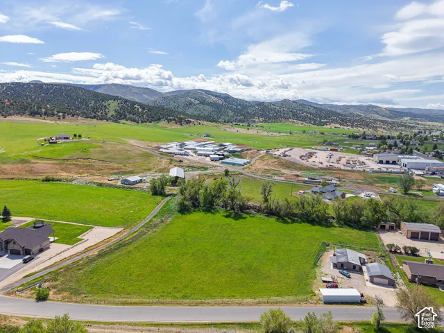 Expansive green acreage with distant mountain scenery