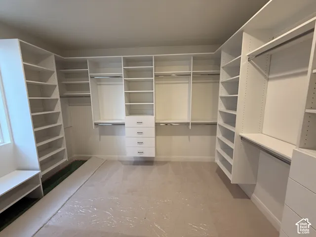 Built-in storage solutions with multiple shelving units, hanging rods, and integrated drawer sets