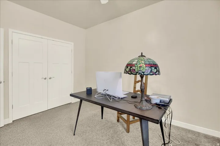 Neutral-toned walls complement the light gray patterned carpeting