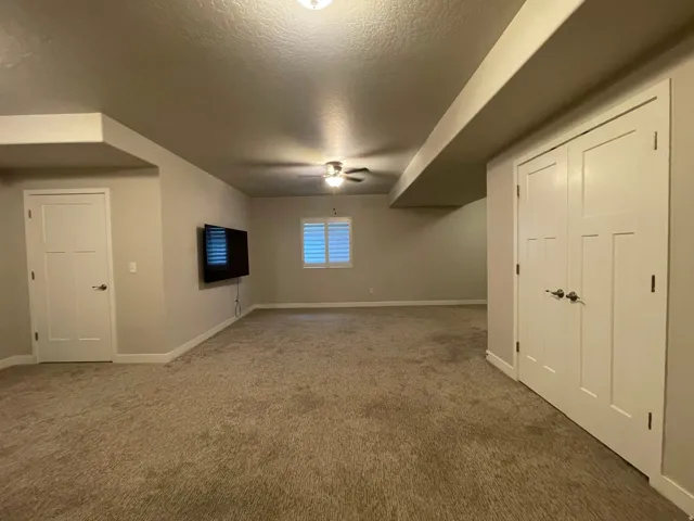 Carpeted room with recessed lighting and a ceiling fan