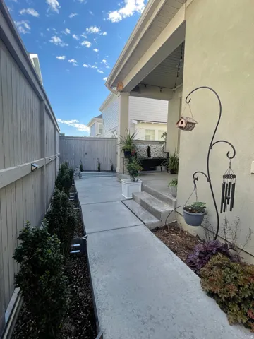 Covered patio with a multi-tiered water feature and concrete steps