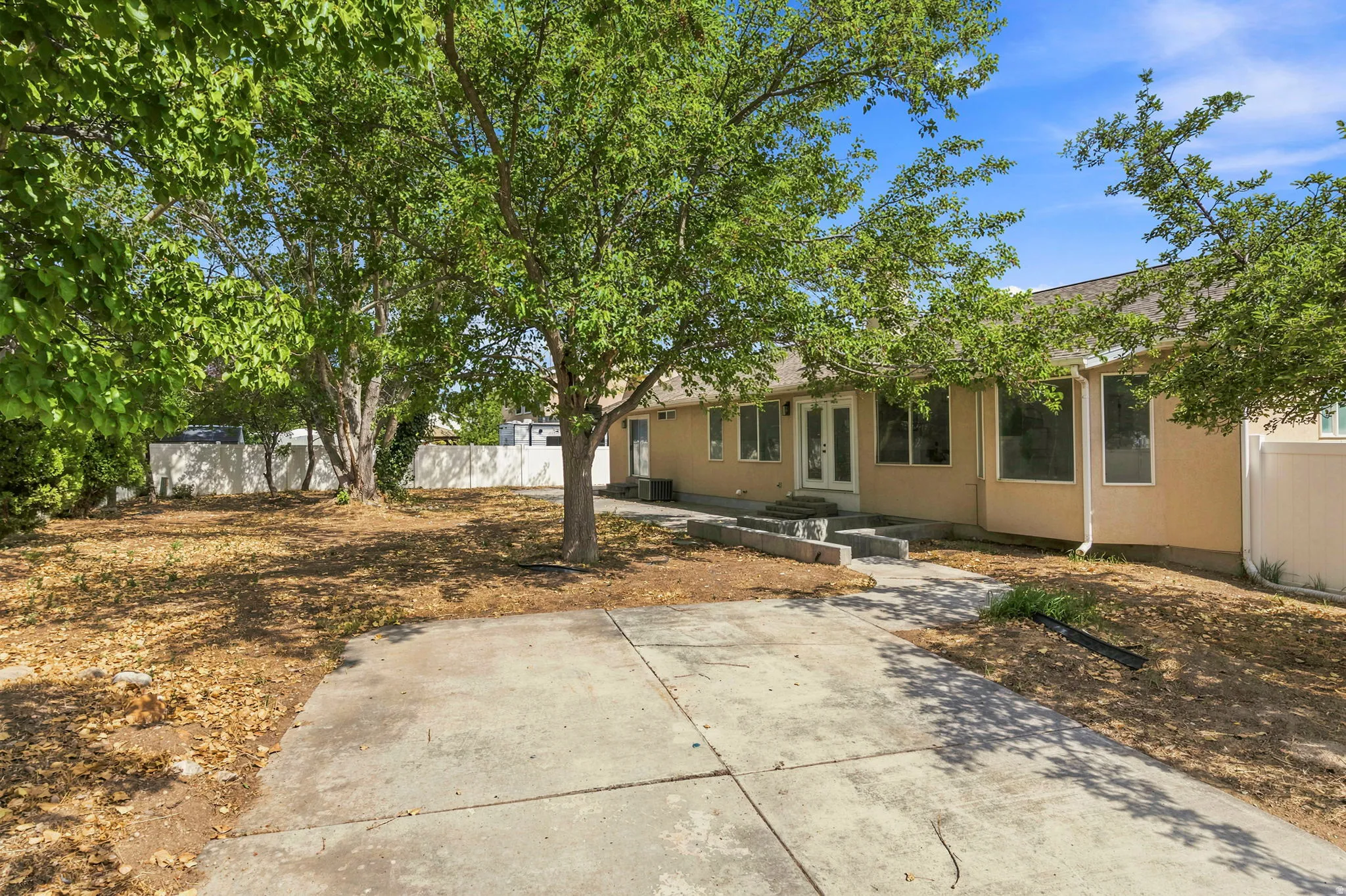 Spacious front yard with mature trees providing ample shade