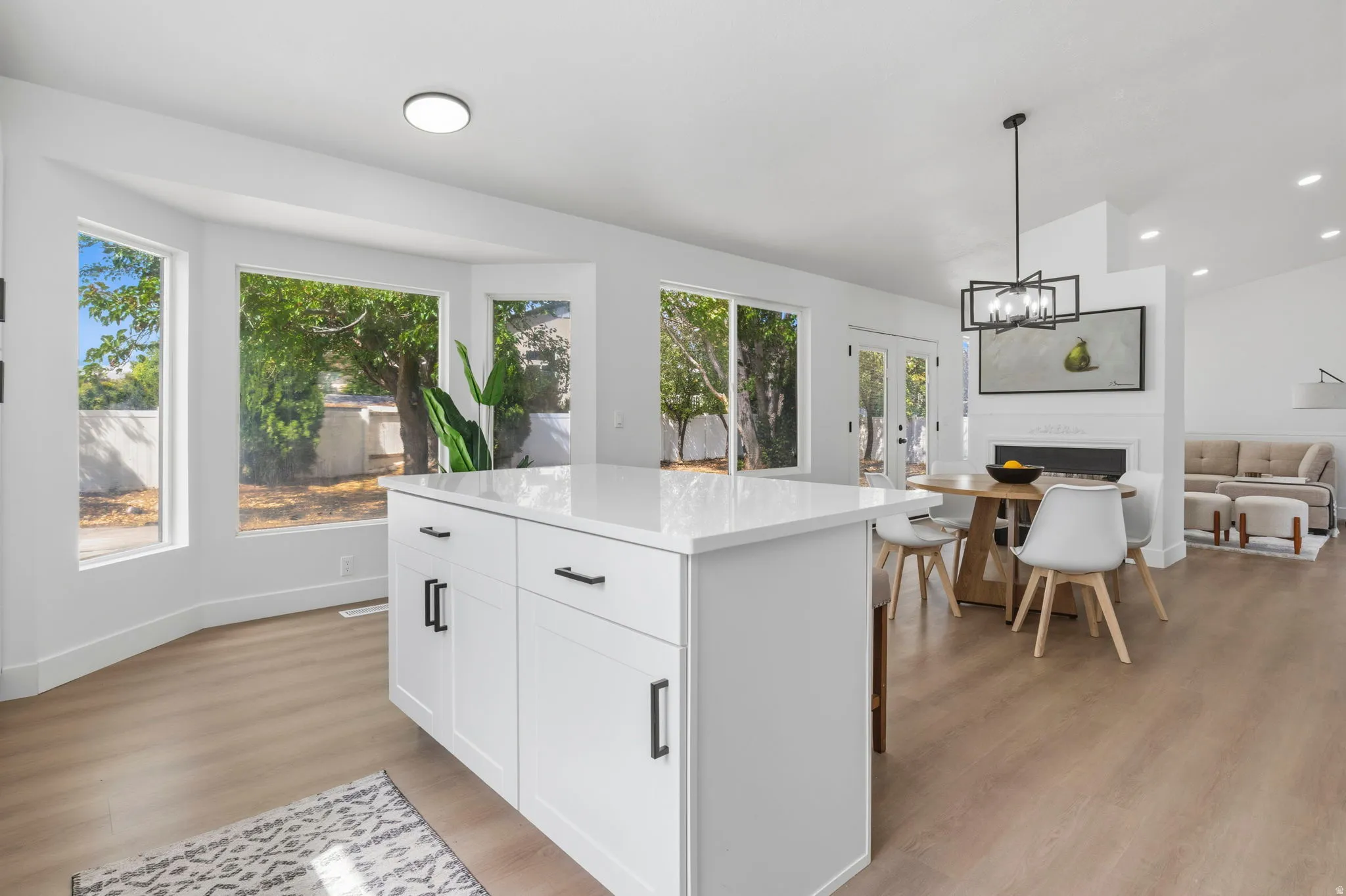 Kitchen island with white cabinetry and a light-toned countertop