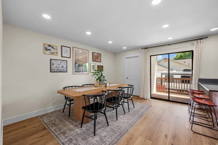 Dining area featuring recessed lighting, light wood-finish flooring, and a sliding glass door opening to an outdoor deck