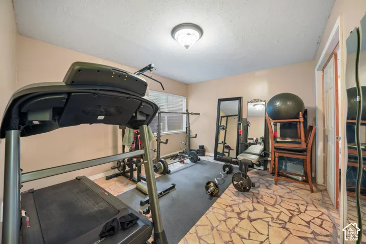 Dedicated room featuring a mix of textured flooring and recessed lighting