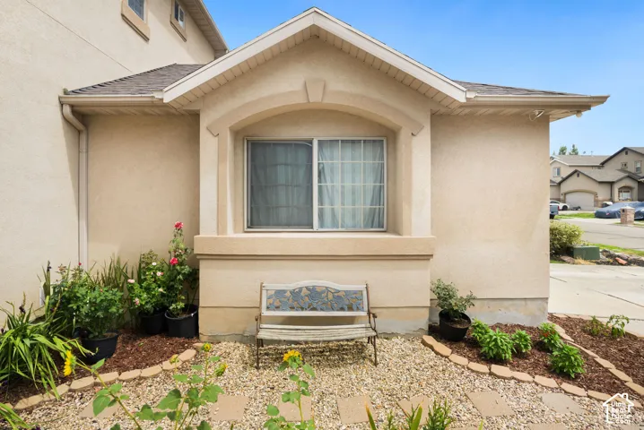 Stucco exterior featuring an arched window alcove