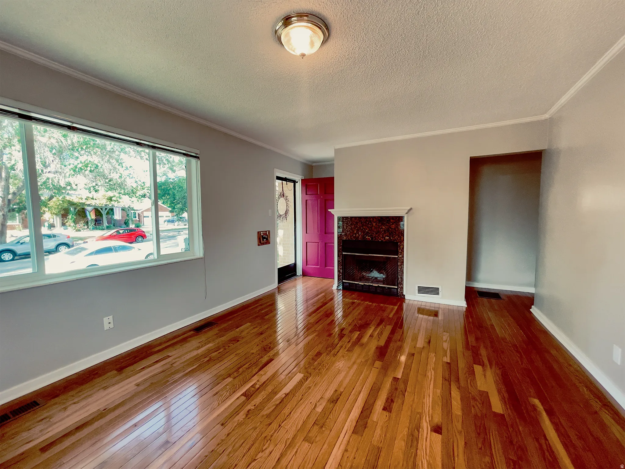 Warm wood-finish flooring extending throughout the room