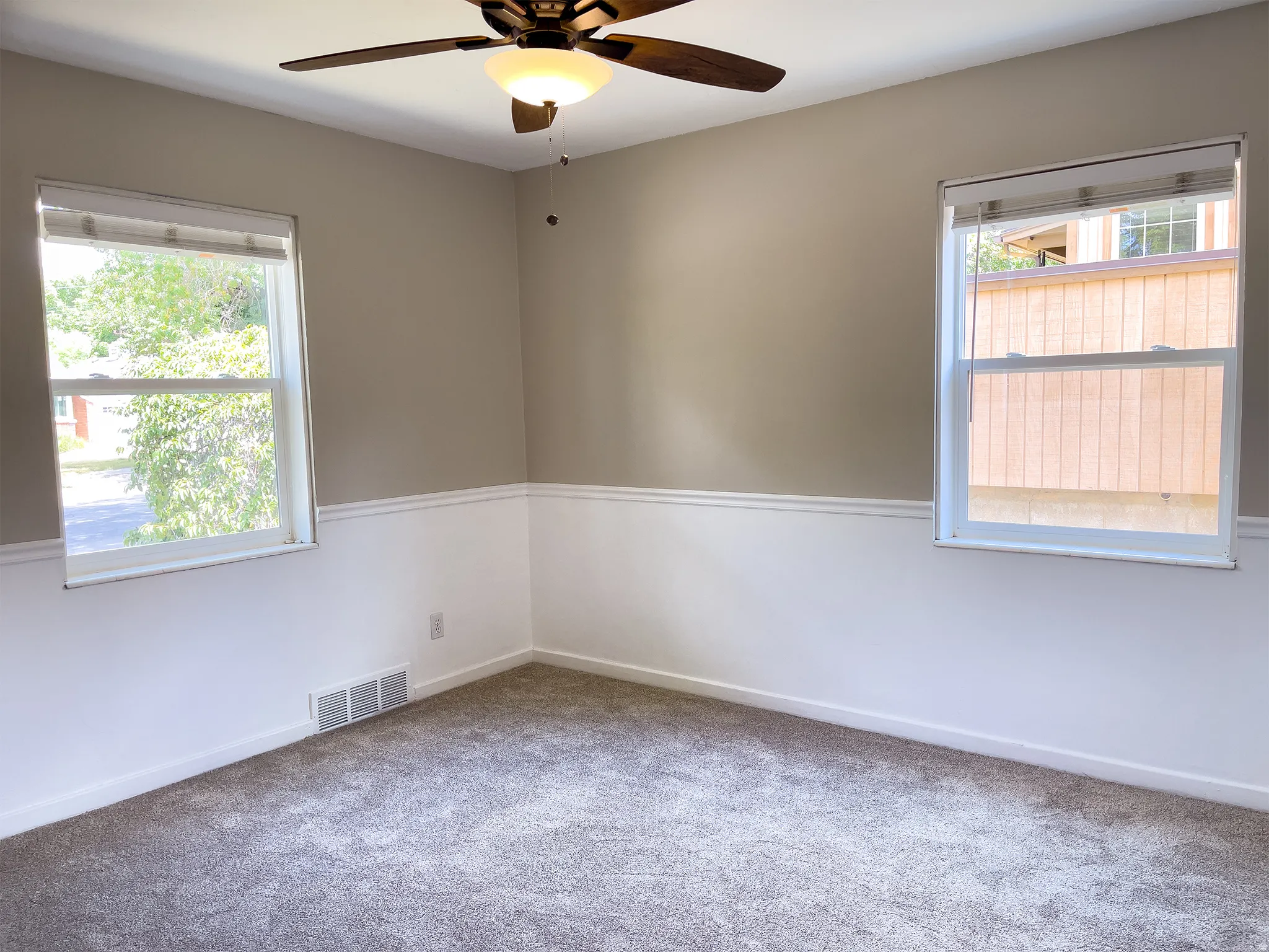 Neutral-toned walls with wainscoting and crown molding accents