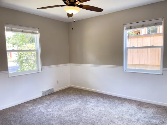Neutral-toned walls with wainscoting and crown molding accents