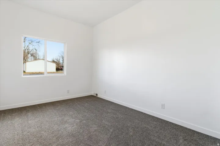 Room featuring white walls, white trim, and gray carpet