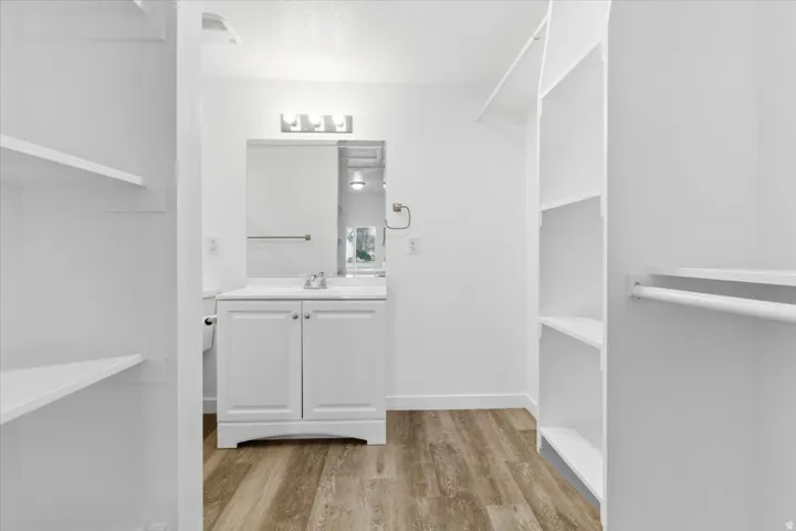Walk-in closet with integrated shelving and hanging rods