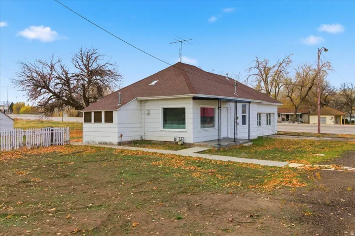 White-sided single-story home with a brown shingle roof