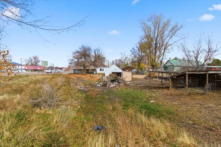 Expansive open lot with a mix of grass and dry brush