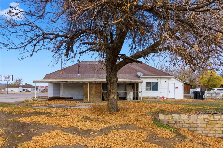 Single-story structure featuring a pitched roofline and a covered porch with supporting columns