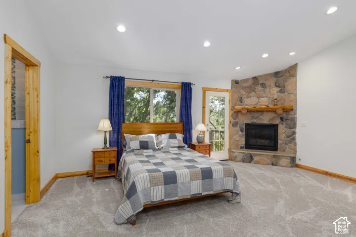 Corner stone fireplace with a substantial log mantel
