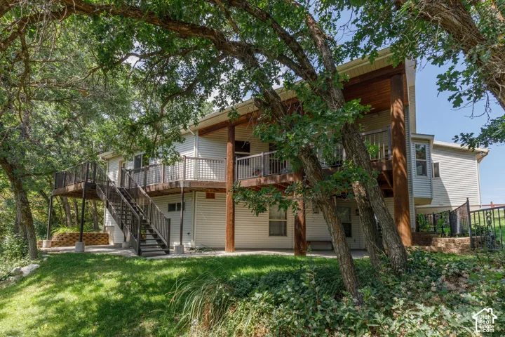 Multi-level rear decking with wood-finish flooring and metal railings