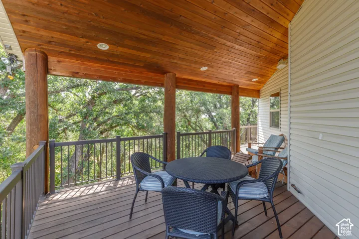 Covered deck with wood-finish ceiling, recessed lighting, and durable plank flooring